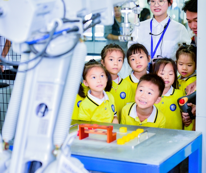 16、2020年11月18日，在广西梧州商贸学校幼儿园的小朋友饶有兴趣参观工业智能制造体验，产生好奇，感受科技的魅力。