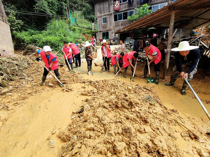 2022年6月23日贵州省从江县丙妹镇党员群众在清理道路淤泥