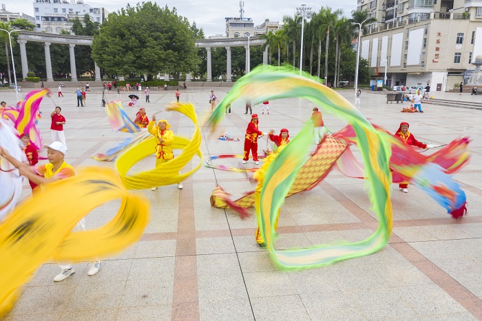 7、2022年9月30日，“彩带龙”爱好者在广西梧州市龙圩区世纪广场舞“彩带龙”，强身健体。（何华文）