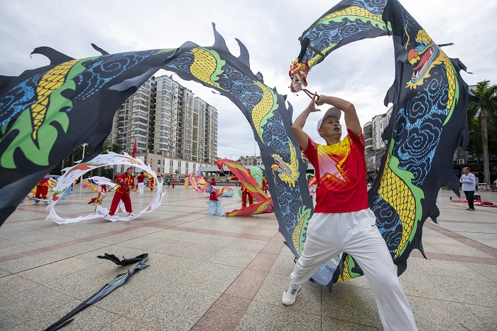 9、2022年9月30日，“彩带龙”爱好者在广西梧州市龙圩区世纪广场舞“彩带龙”，强身健体。（何华文）