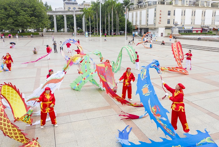 10、2022年9月30日，“彩带龙”爱好者在广西梧州市龙圩区世纪广场舞“彩带龙”，强身健体。（何华文）