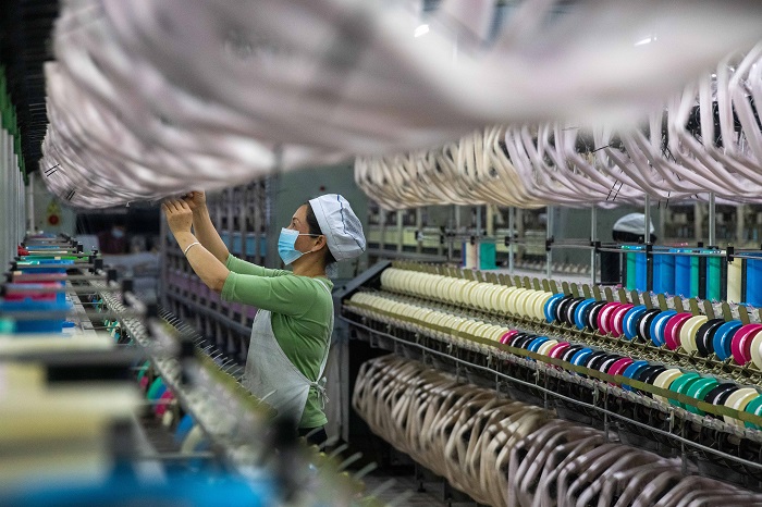 6、2023年3月15日，广西梧州市蒙山县一家纺织企业生产车间内，工人们在生产线上忙碌，生产车间一片繁忙。（何华文）