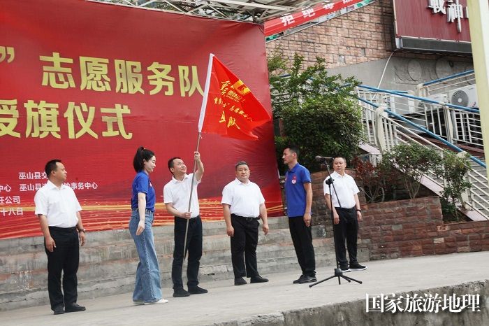 图4：重庆市“雷锋的士”志愿服务队总队长向涛向重庆“雷锋的士”志愿服务队巫山支队授旗。2023年5月18日，摄于重庆巫山县城。唐金生