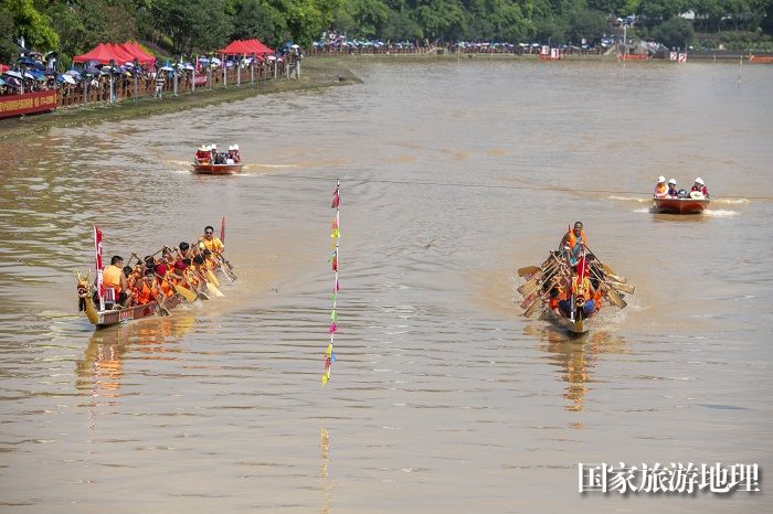 12、2023年6月27日，在广西岑溪市义昌江健身公园至南北大桥河段，参赛的龙舟队员奋力划桨。（何华文）