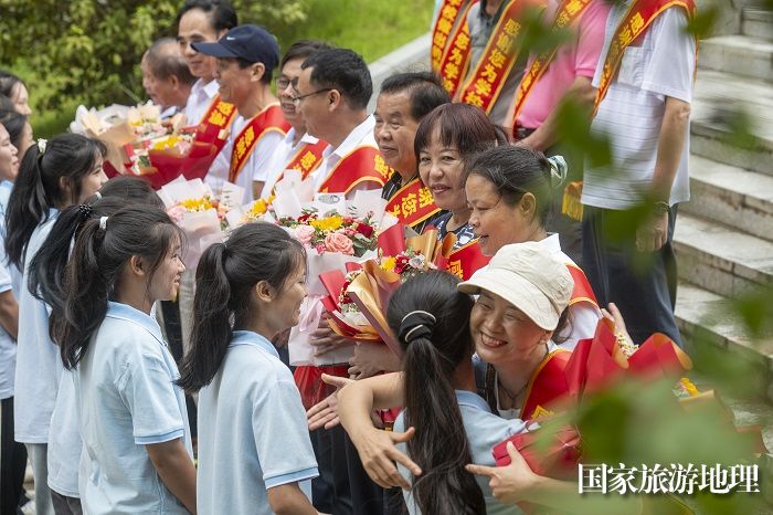 17、2023年9月8日，在广西梧州商贸学校，学生们手捧鲜花、整齐列队，热情地为老师们送上了鲜花和拥抱。（何华文）