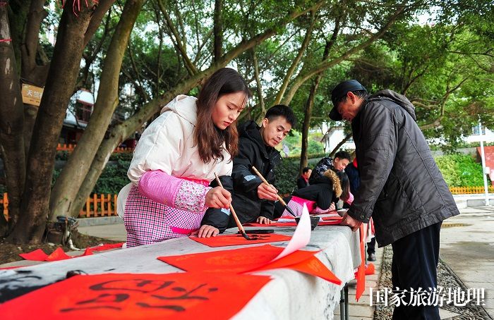 2024年1月22日，在贵州省从江县城区街道，书法爱好者为市民书写春联。 (3)